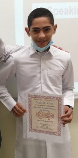 A graduate holding a certificate of achievement